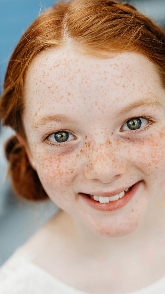 Beautiful Redhead Girl With Natural Freckles Close-Up Phone Wallpaper