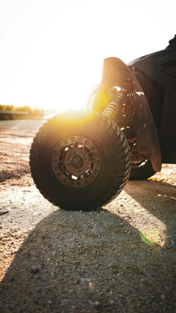 Golden Hour Off-Road Racing ATV Wheel Close-up Mobile Wallpaper
