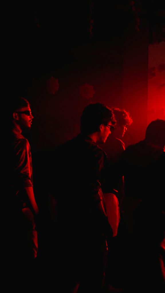 Red Lit Party Vibes Cinematic Group Silhouette Mobile Wallpaper