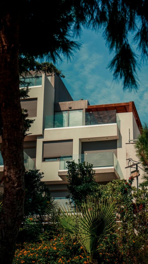 Modern Luxury Apartment Building Under Sunny Blue Sky Wallpaper