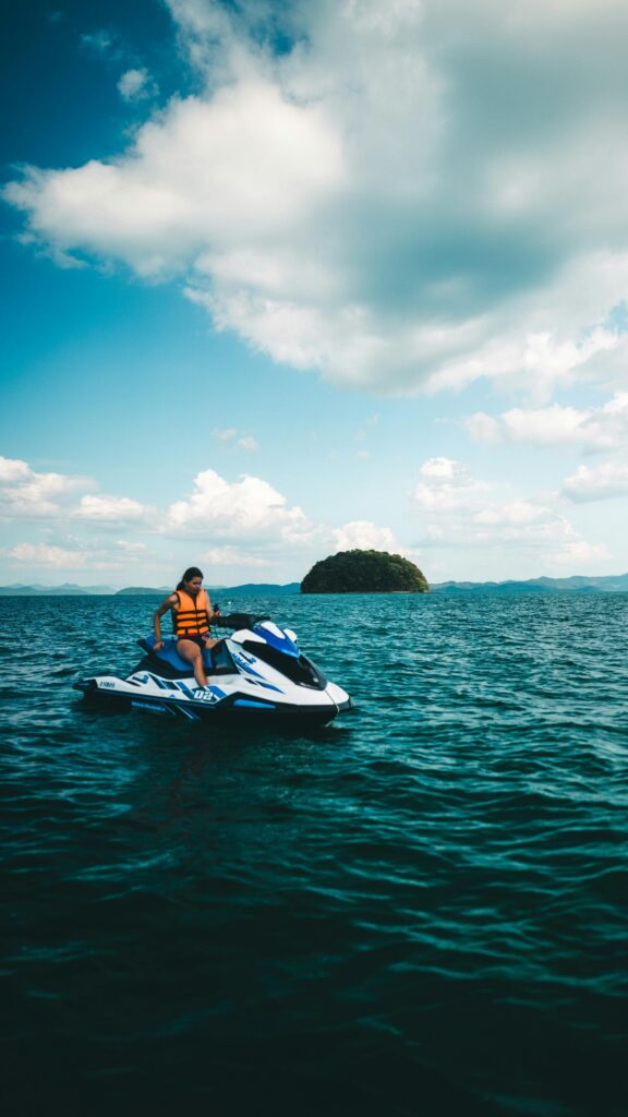 Woman Riding a Jet Ski in Tropical Island Ocean Mobile Wallpaper