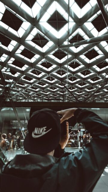 First-Person Perspective Photographer at Modern Train Station Wallpaper