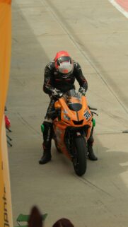 Professional Motorcycle Racer on Orange Superbike Wallpaper