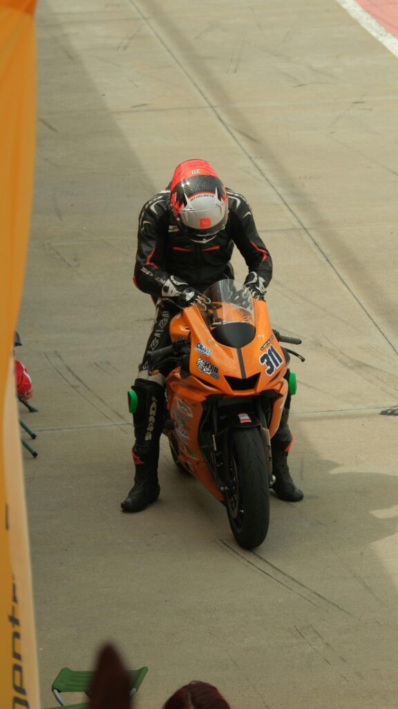 Professional Motorcycle Racer on Orange Superbike Wallpaper