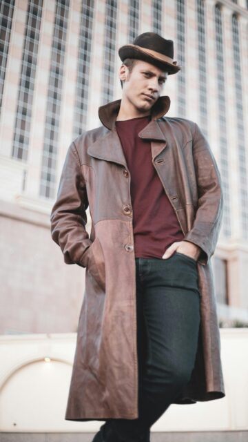 Stylish Man in Fedora and Leather Trench Coat Mobile Wallpaper