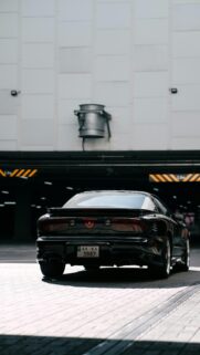Sleek Black Pontiac Firebird Sports Car Urban Parking Wallpaper