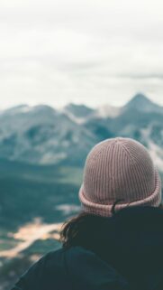 Woman Looking at Mountain Peaks Pink Beanie Adventure Wallpaper