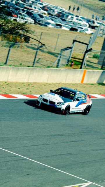 BMW M2 Racing Car on Track High-Speed Action Mobile Wallpaper