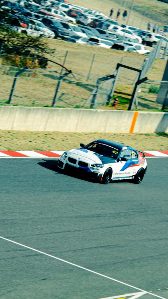 BMW M2 Racing Car on Track High-Speed Action Mobile Wallpaper