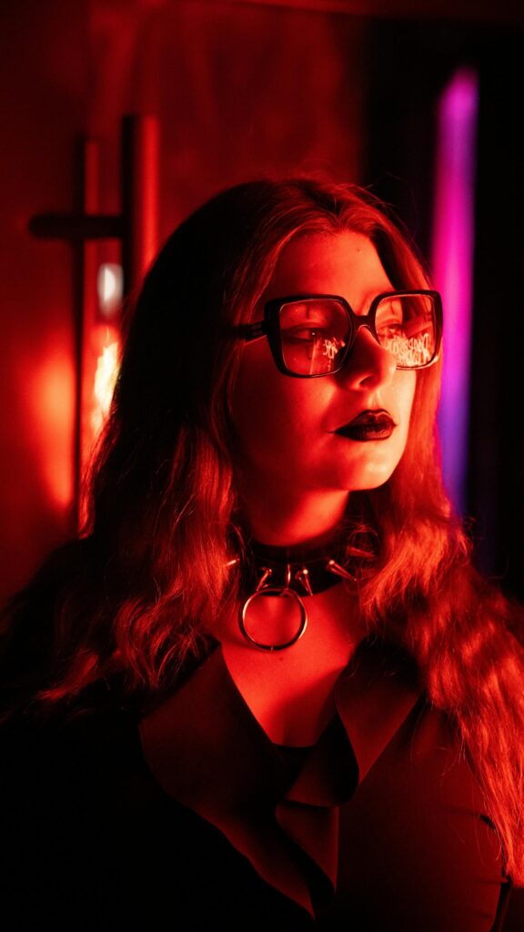 Gothic Girl with Spiked Choker and Retro Glasses Red Aesthetic Wallpaper