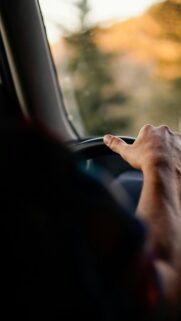 Driver Holding Steering Wheel Golden Hour Road Trip Mobile Wallpaper