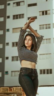 Beautiful Young Woman Posing in Striped Crop Top Mobile Wallpaper