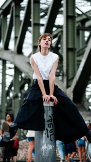 Stylish Woman on Industrial Bridge Aesthetic Phone Wallpaper