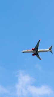 Lion Air Passenger Plane Flying Against Clear Blue Sky Wallpaper