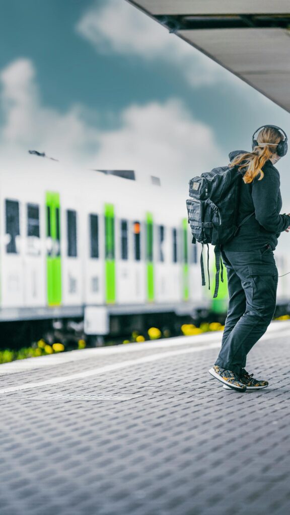 Commuter Waiting for Train on Station Platform Mobile Wallpaper
