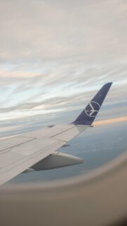 Breathtaking Airplane Wing View Above Clouds Sunset Wallpaper