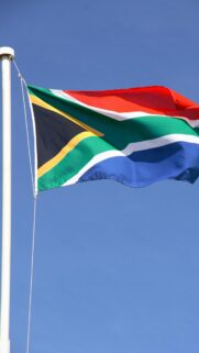 South African Flag Waving Against Clear Blue Sky Mobile Wallpaper