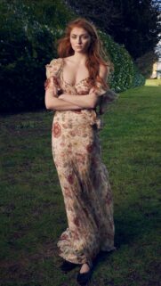 Sophie Turner Portrait in Elegant Floral Maxi Dress Outdoor Wallpaper