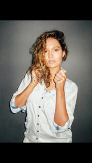 Beautiful Young Woman Wearing a Casual Distressed Denim Shirt Portrait