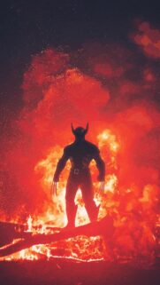 Dark Silhouette Superhero Amidst Intense Fire Mobile Wallpaper