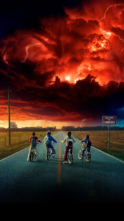 Four Kids Cycling Toward a Stormy Red Sky Mobile Wallpaper