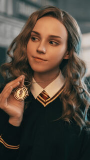 Young Witch Holding Time Turner Mobile Wallpaper