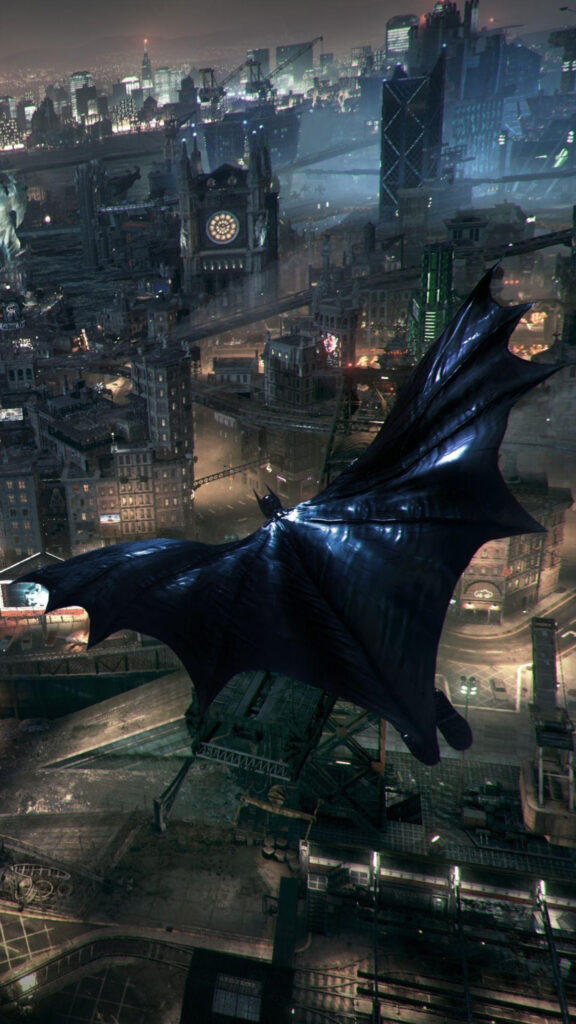 Batman Gliding Over Gotham City Mobile Wallpaper
