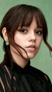 Close-up Portrait of a Woman with Green Earrings Mobile Wallpaper