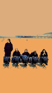 Oasis Band Members Sitting at Beach Mobile Wallpaper