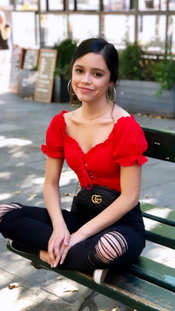 Jenna Ortega Sitting on a Bench Mobile Wallpaper