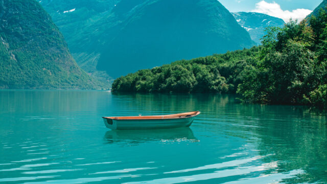 Serene Turquoise Fjord with a Lonely Boat Mobile Wallpaper
