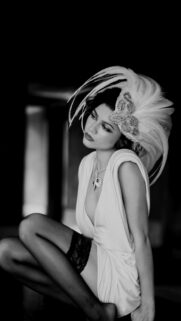 Elegant Woman in Feathered Headpiece Portrait Mobile Wallpaper