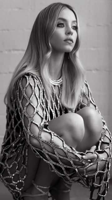 Stunning Blonde Woman in Metallic Mesh Dress Mobile Wallpaper