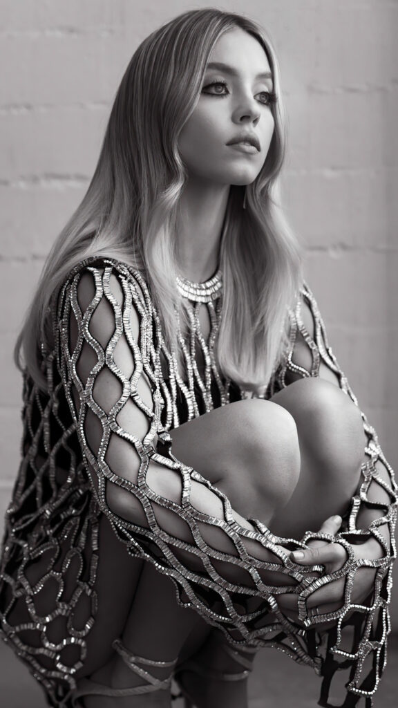 Stunning Blonde Woman in Metallic Mesh Dress Mobile Wallpaper