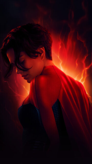 Dramatically Lit Heroic Woman in Red Cape Mobile Wallpaper