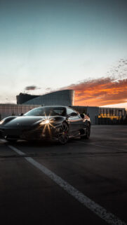 Stunning Black Ferrari at Golden Hour Mobile Wallpaper