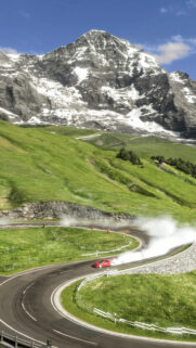 Red Sports Car Drifting on Alpine Mountain Pass Mobile Wallpaper