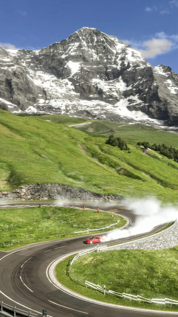 Red Sports Car Drifting on Alpine Mountain Pass Mobile Wallpaper