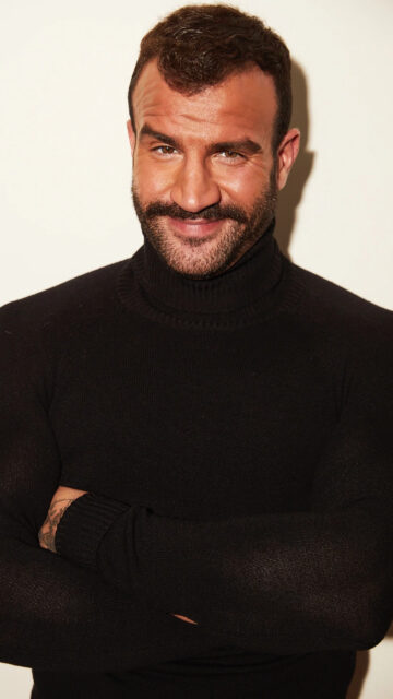 Masculine Portrait of a Man in a Black Turtleneck Mobile Wallpaper