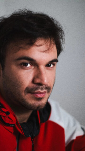 Young Man with Stubble Wearing a Red Jacket Mobile Wallpaper