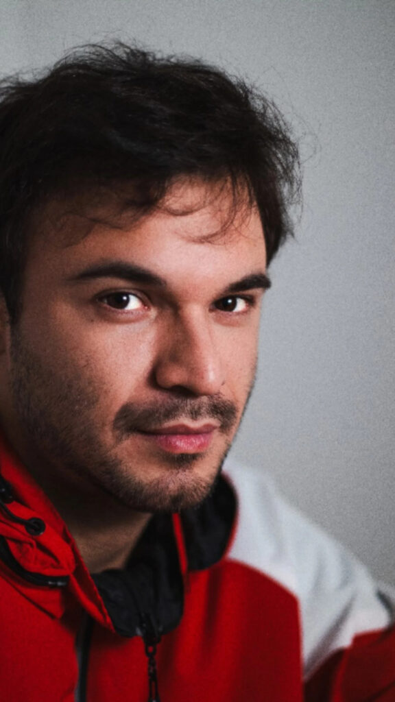Young Man with Stubble Wearing a Red Jacket Mobile Wallpaper