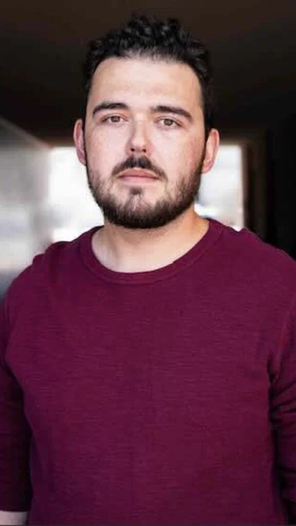 Portrait of a Bearded Man in a Maroon Shirt Mobile Wallpaper