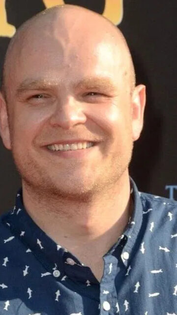 Portrait of a Smiling Man in a Patterned Shirt Mobile Wallpaper