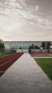 Modern Sports Arena with Running Track at Sunset Phone Wallpaper
