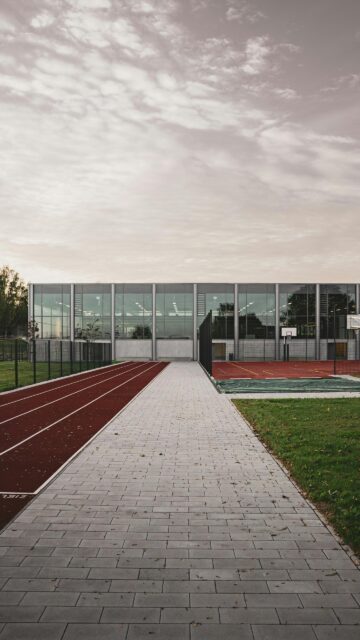 Modern Sports Arena with Running Track at Sunset Phone Wallpaper