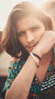 Handsome Young Man with Long Hair and Stylish Shirt Mobile Wallpaper