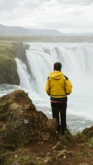 Traveler at Goðafoss Waterfall in Iceland Mobile Wallpaper
