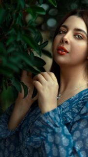 Beautiful Woman Touching Green Leaves Close-up Portrait Wallpaper