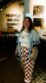 Joyful Person in Trendy Flame Shirt and Checkerboard Pants Wallpaper