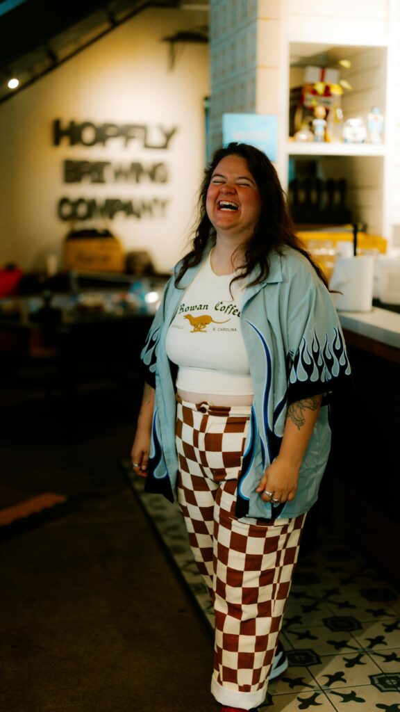 Joyful Person in Trendy Flame Shirt and Checkerboard Pants Wallpaper
